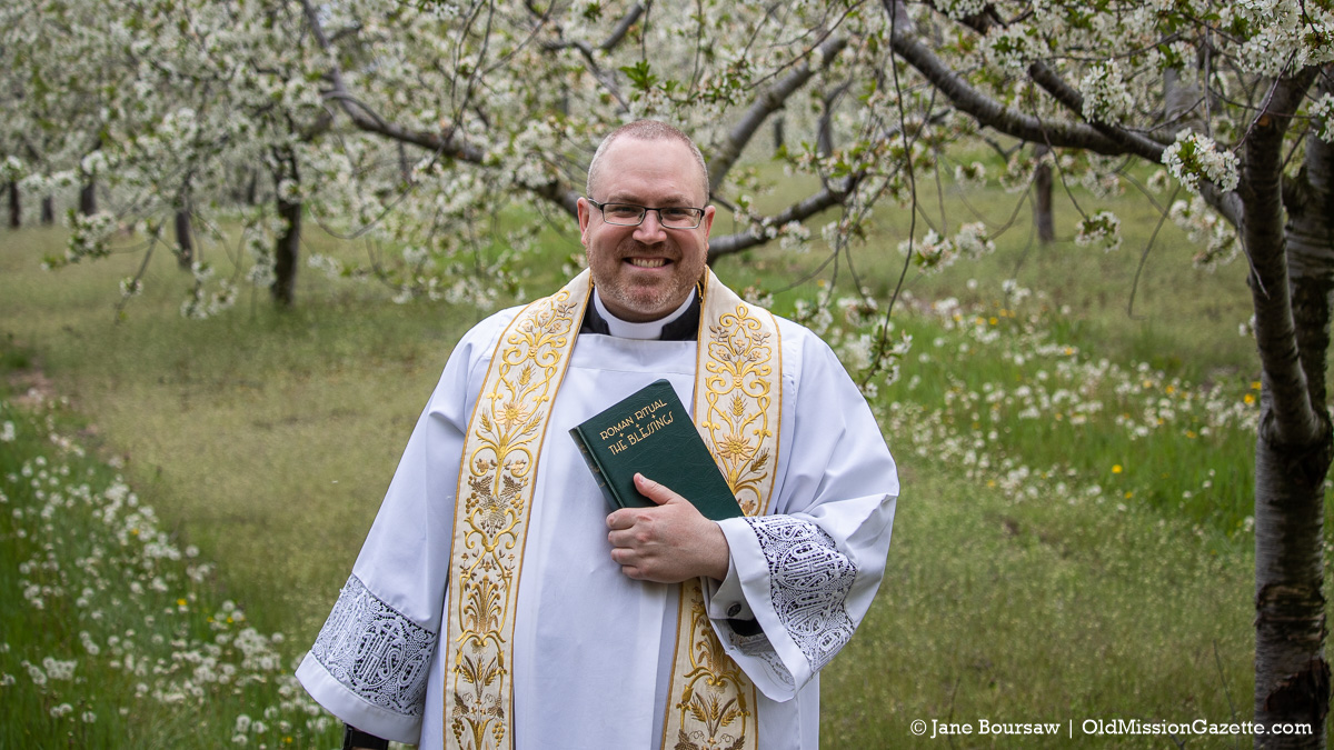 Blessing of the Blossoms Planned - History of the Event & How To Get Your Land Blessed 9 Father Rexroat performs the Blessing of the Blossoms on the Old Mission Peninsula | Jane Boursaw Photo