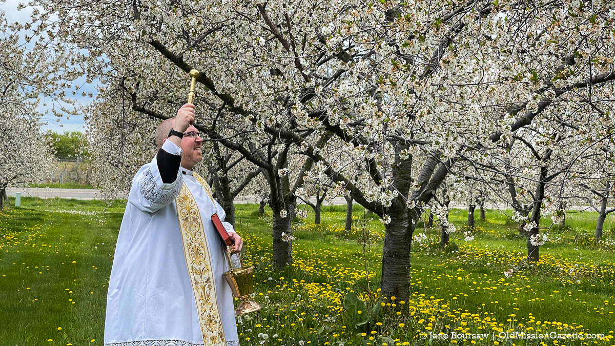 Blessing of the Blossoms Planned - History of the Event & How To Get Your Land Blessed 11 Father Rexroat performs the Blessing of the Blossoms on the Old Mission Peninsula | Jane Boursaw Photo