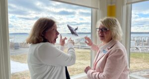 Great Lakes Whale Migration 2025: Vicki Shurly and Nancy Davy spot a whale in Bowers Harbor from the Boathouse Restaurant on the Old Mission Peninsula | Jane Boursaw Photo